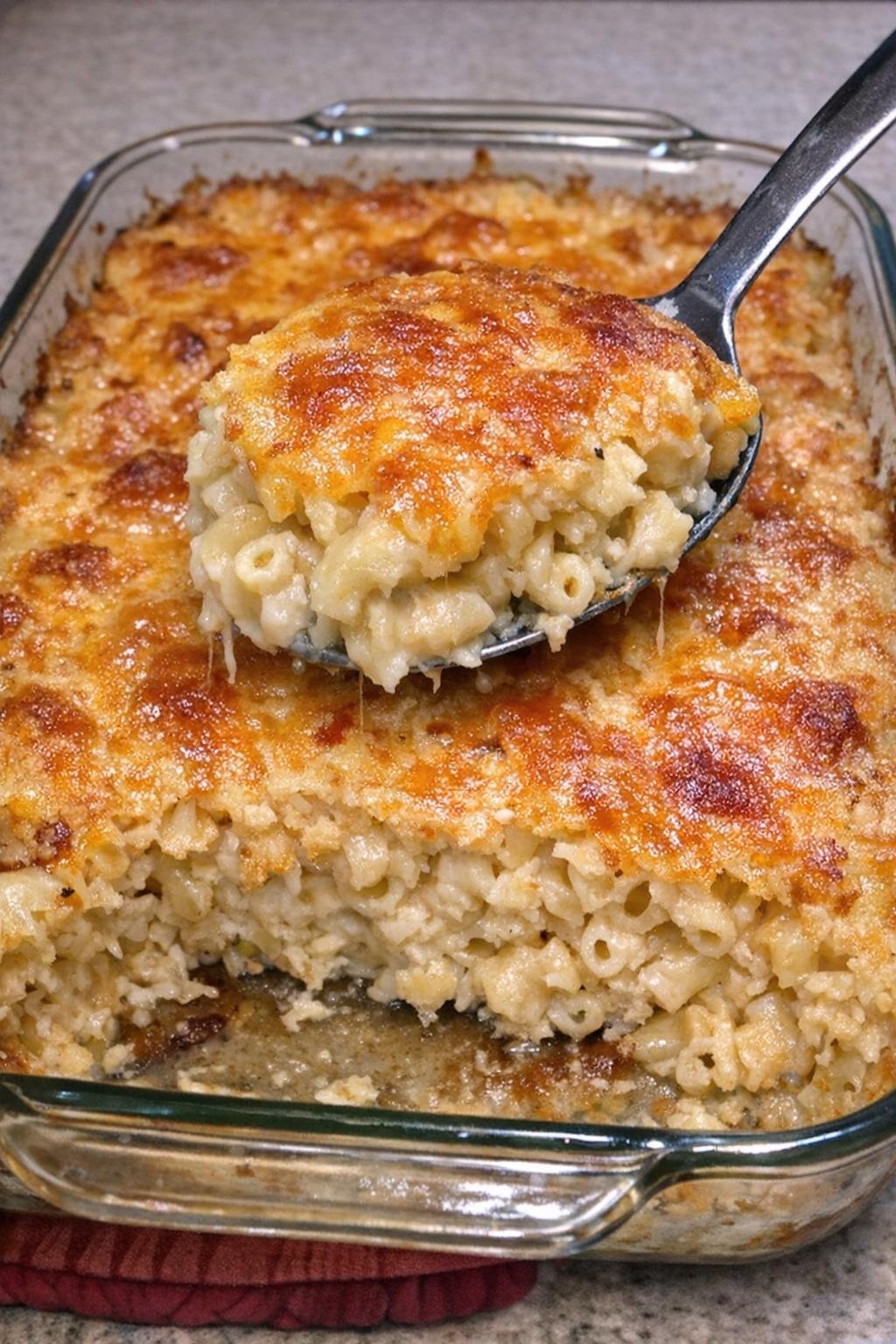 Bubbling golden macaroni bake in a glass dish