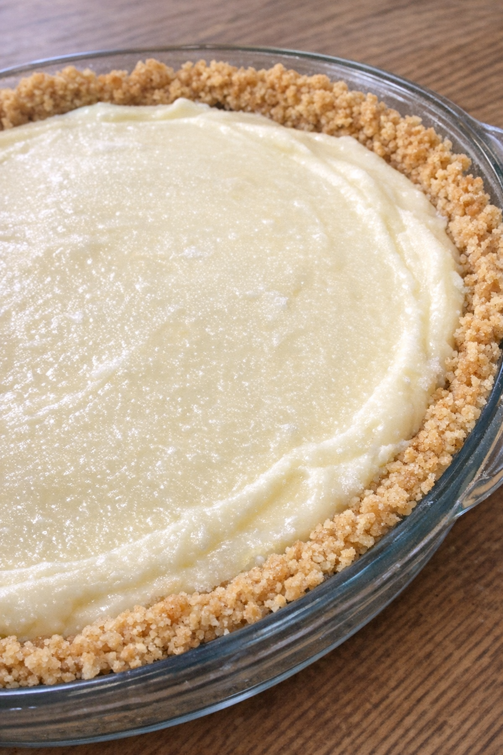Frozen lemonade pie in a glass pie dish