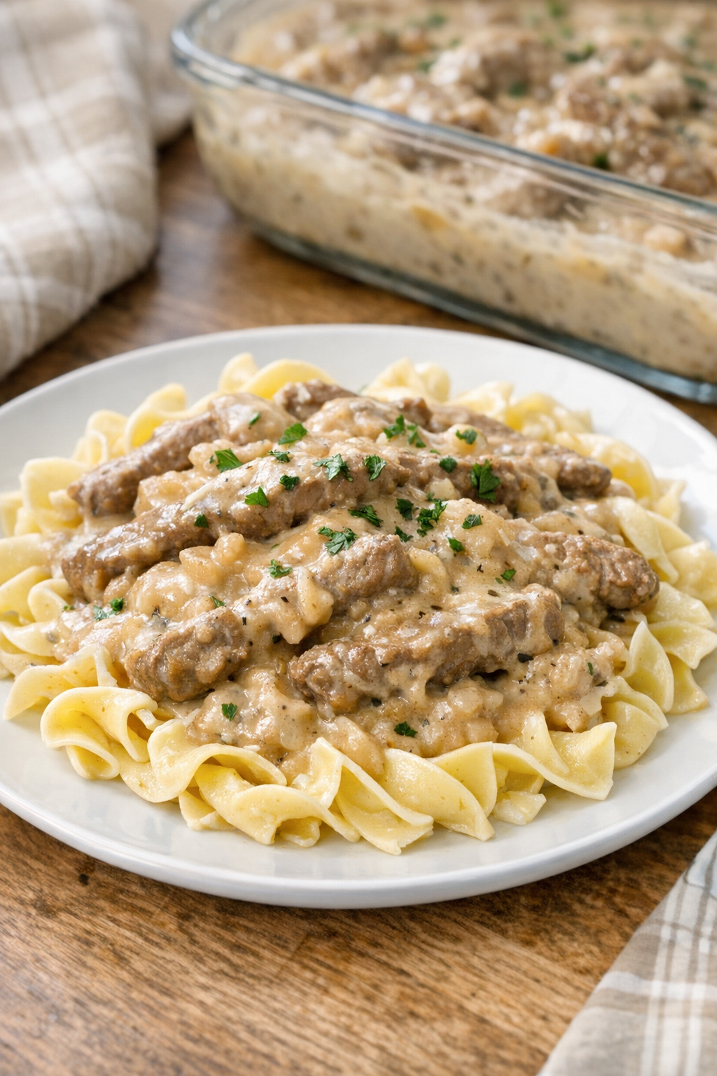 Finished Amish beef stroganoff bake served over egg noodles