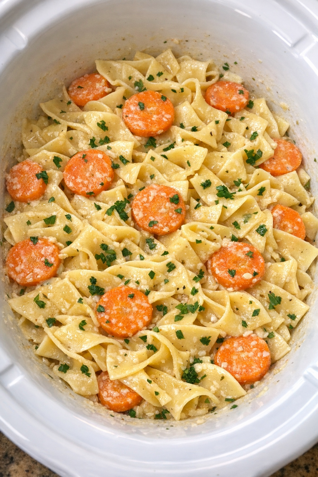 Slow cooker Amish carrot noodles finished in a white slow cooker