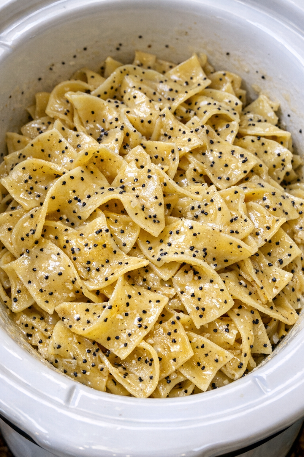 Slow cooker Amish poppy seed noodles in a white slow cooker