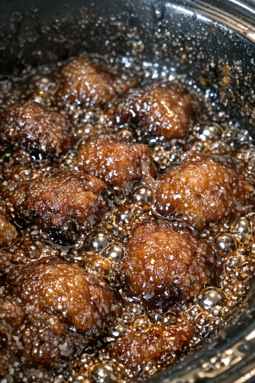 Bubbling espresso-colored sticky dessert in a slow cooker