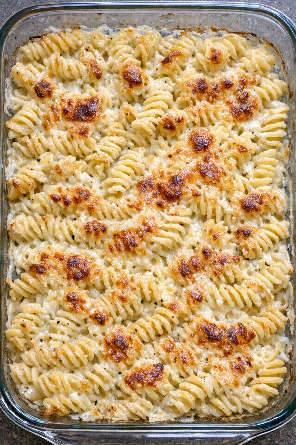 Baked creamy garlic parmesan rotini in a glass baking dish