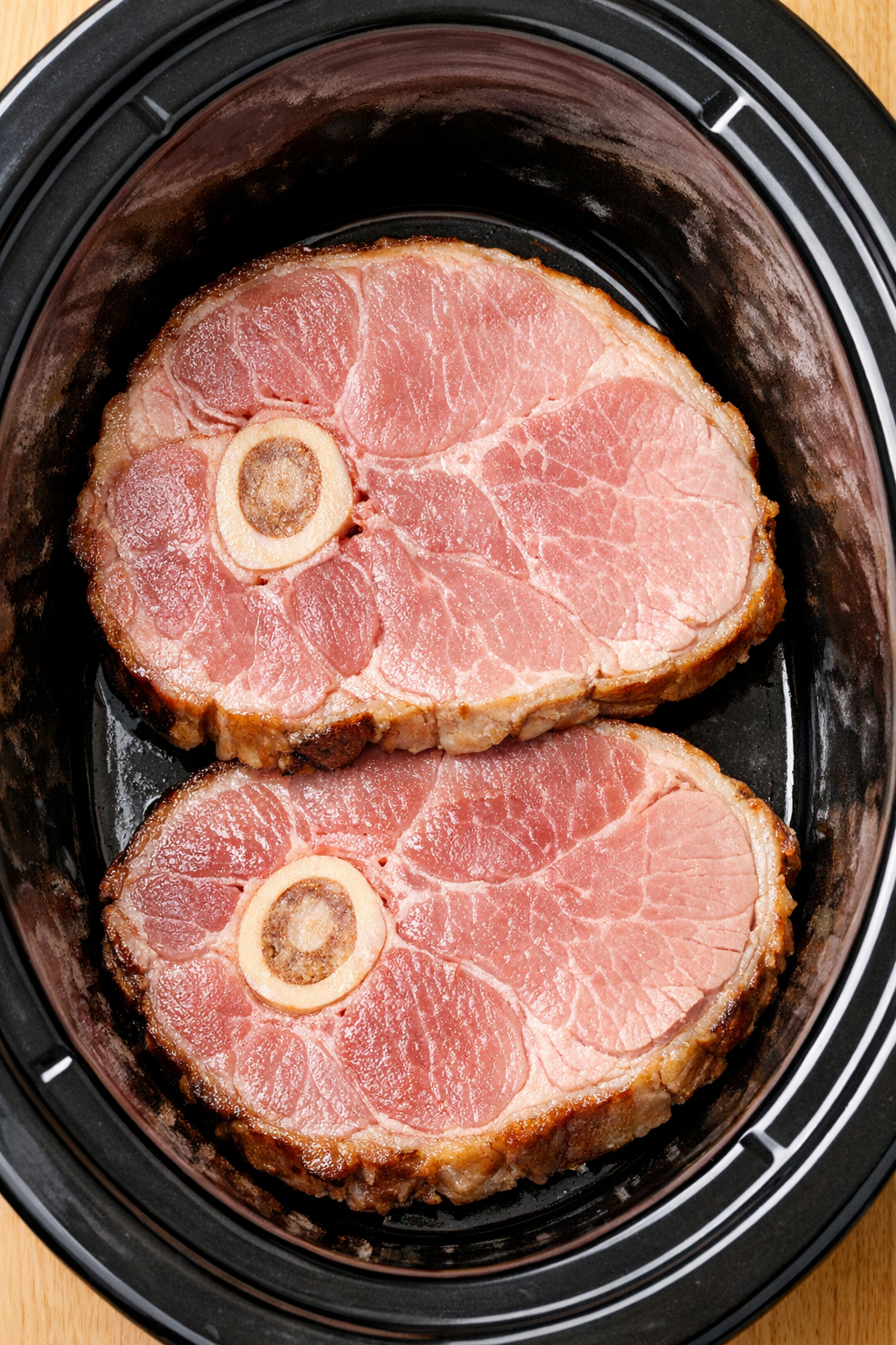 Ham steaks arranged in slow cooker