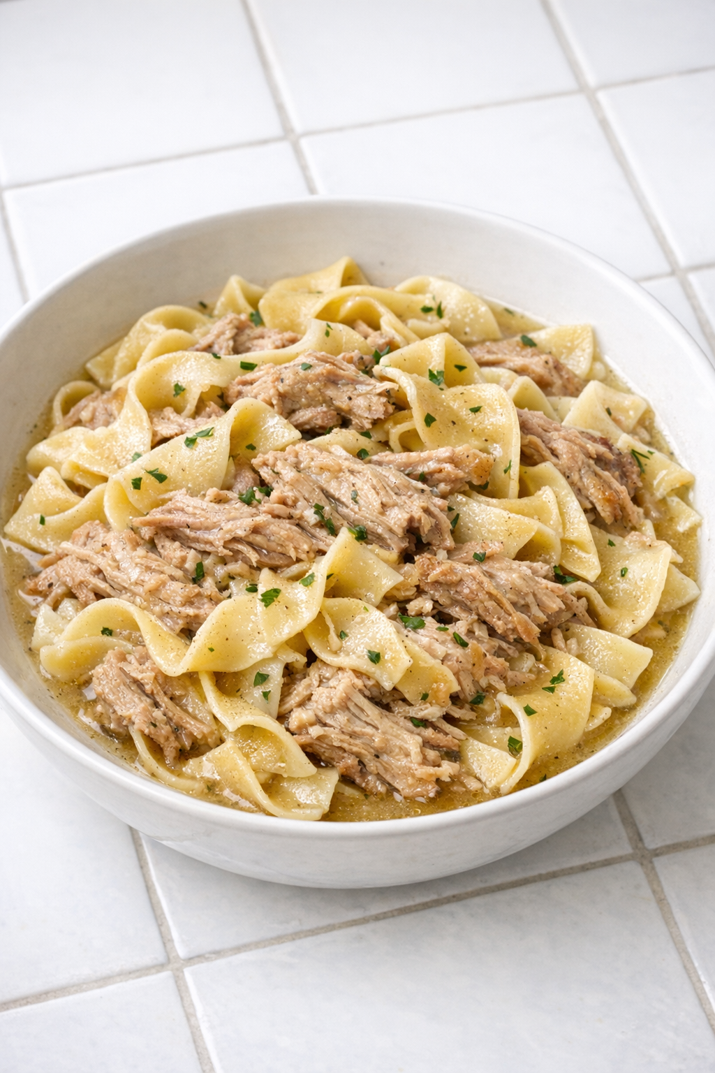 Finished Amish-style pork pasta in a serving bowl