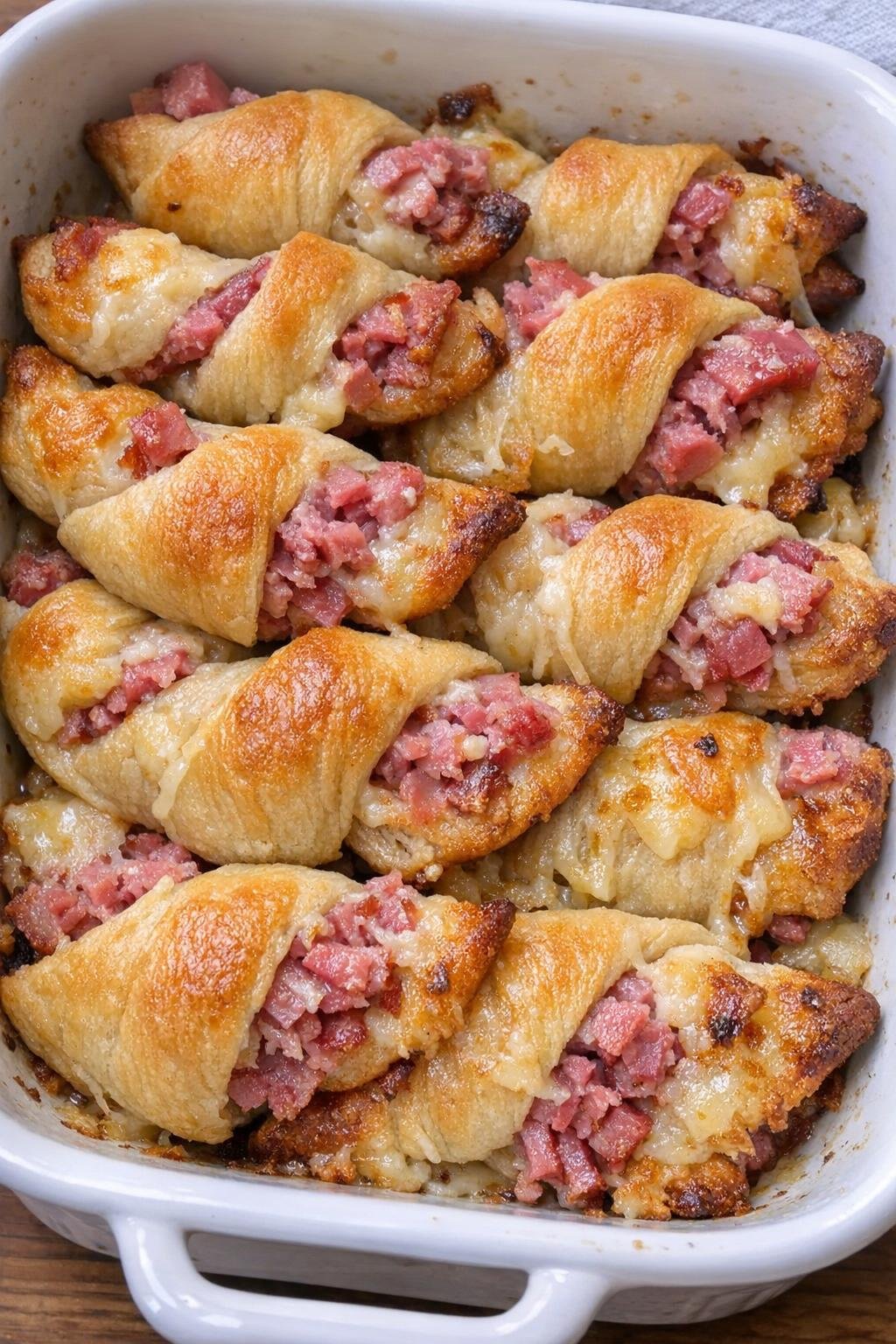 Baked crescent twists filled with corned beef and manchego