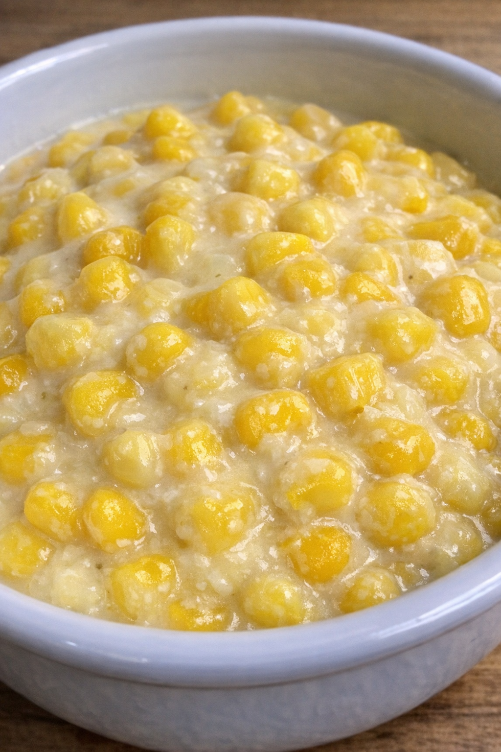 Creamed corn in a white ceramic serving bowl