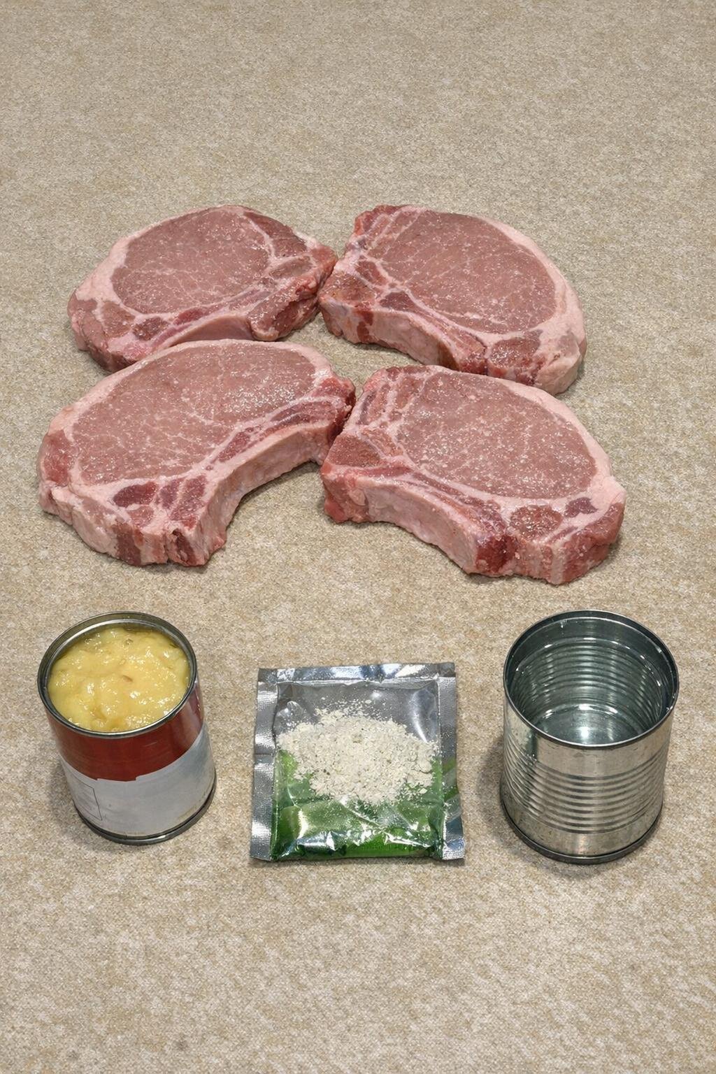 Flat lay of pork chops, soup, water, and ranch mix