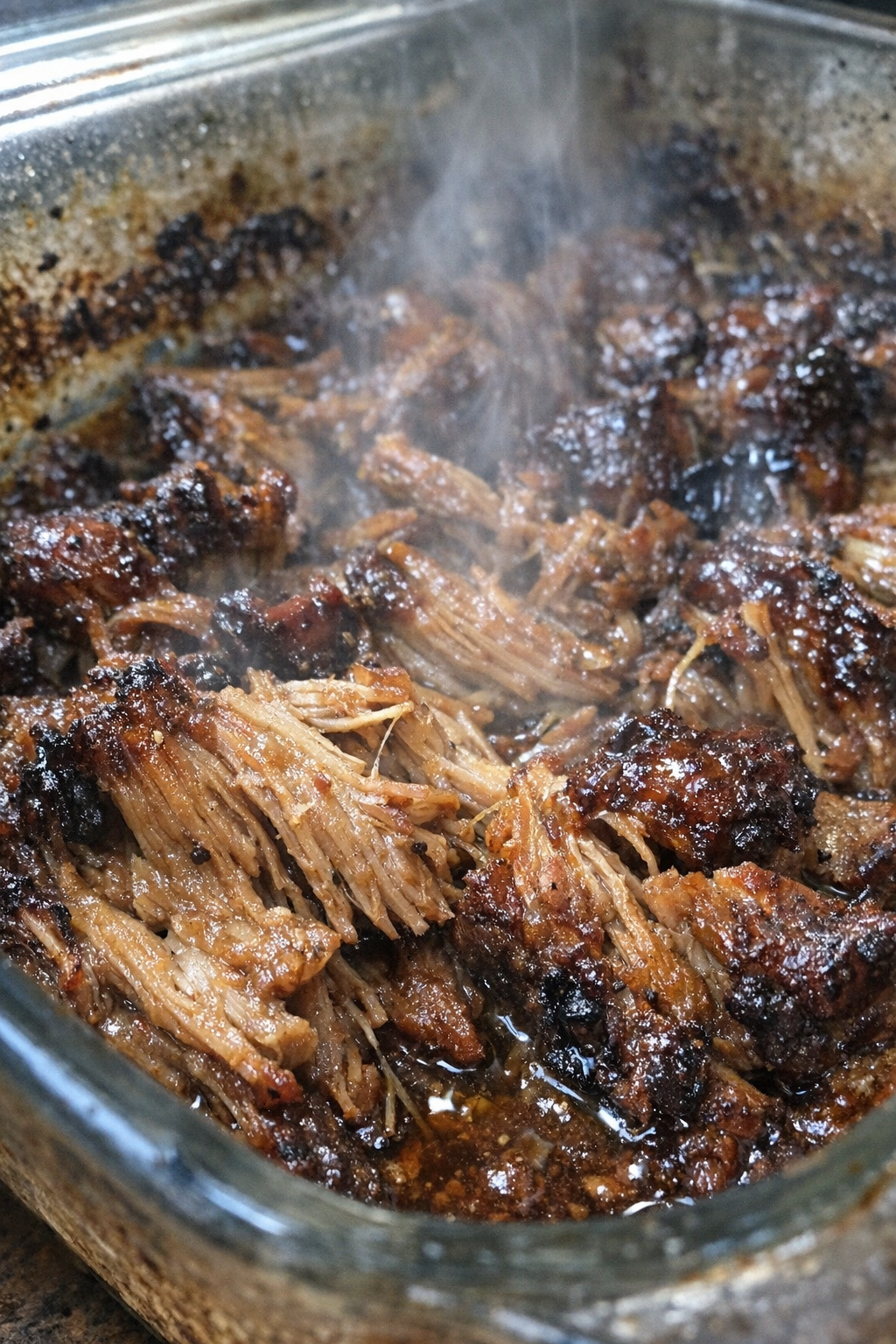 Glossy caramelized roasted dish in a glass baking pan