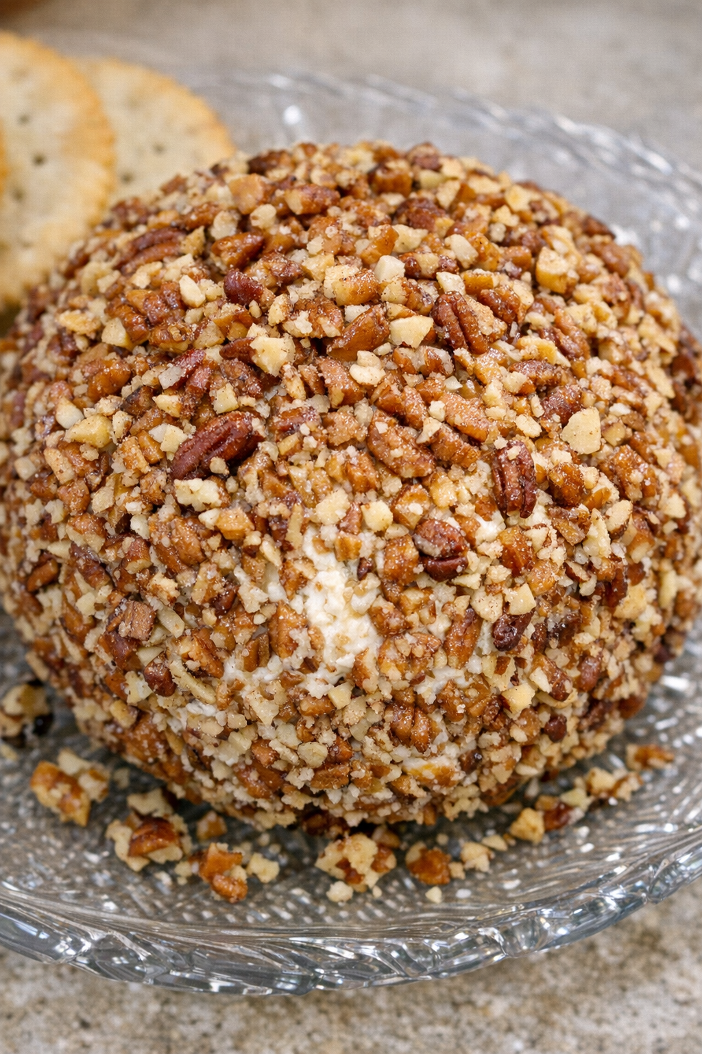 Southern 3-ingredient pecan cheese ball on a glass serving platter