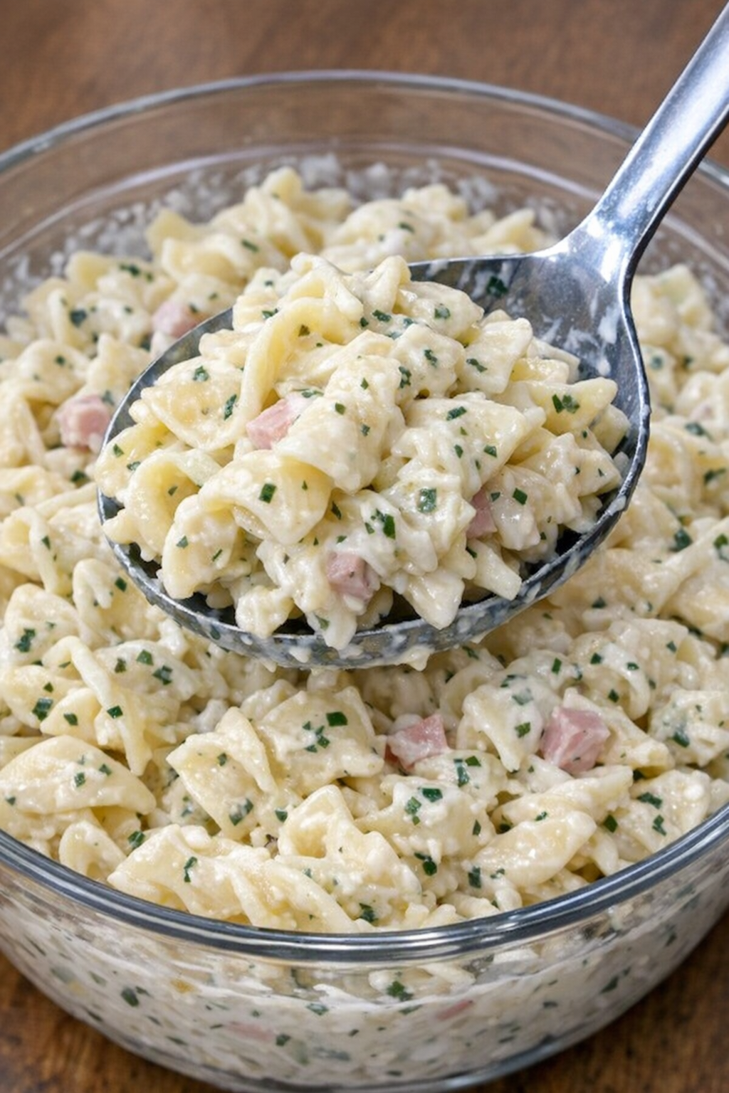 Close-up of creamy pasta langley salad in a glass serving bowl