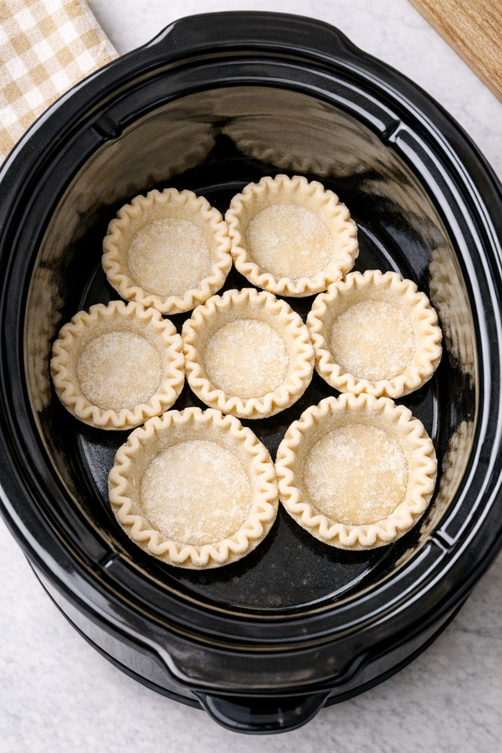 Mini pie crusts arranged in the slow cooker