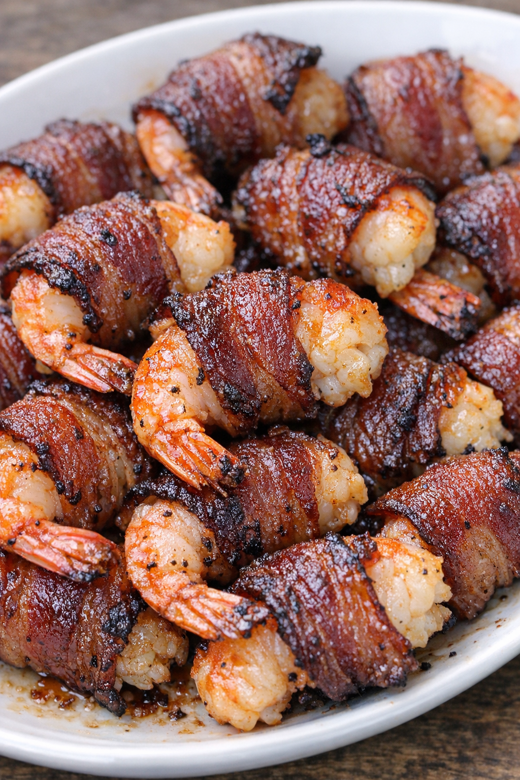 Low carb 2-ingredient bacon shrimp bites on a serving platter