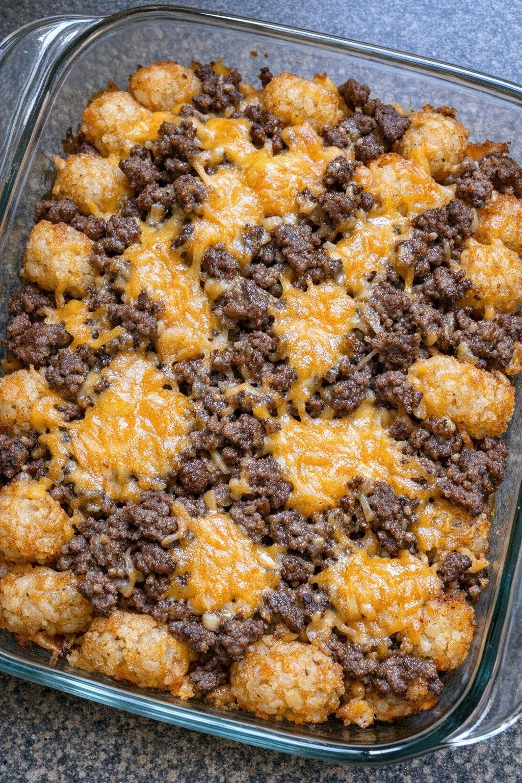 Close up of crispy beef tot bites with melted cheddar