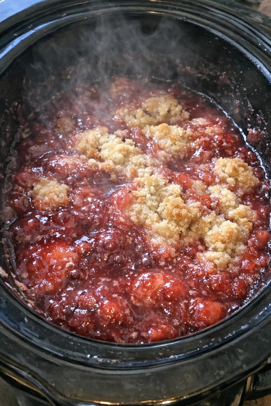 Slow cooker dessert with a bubbling ruby-red topping
