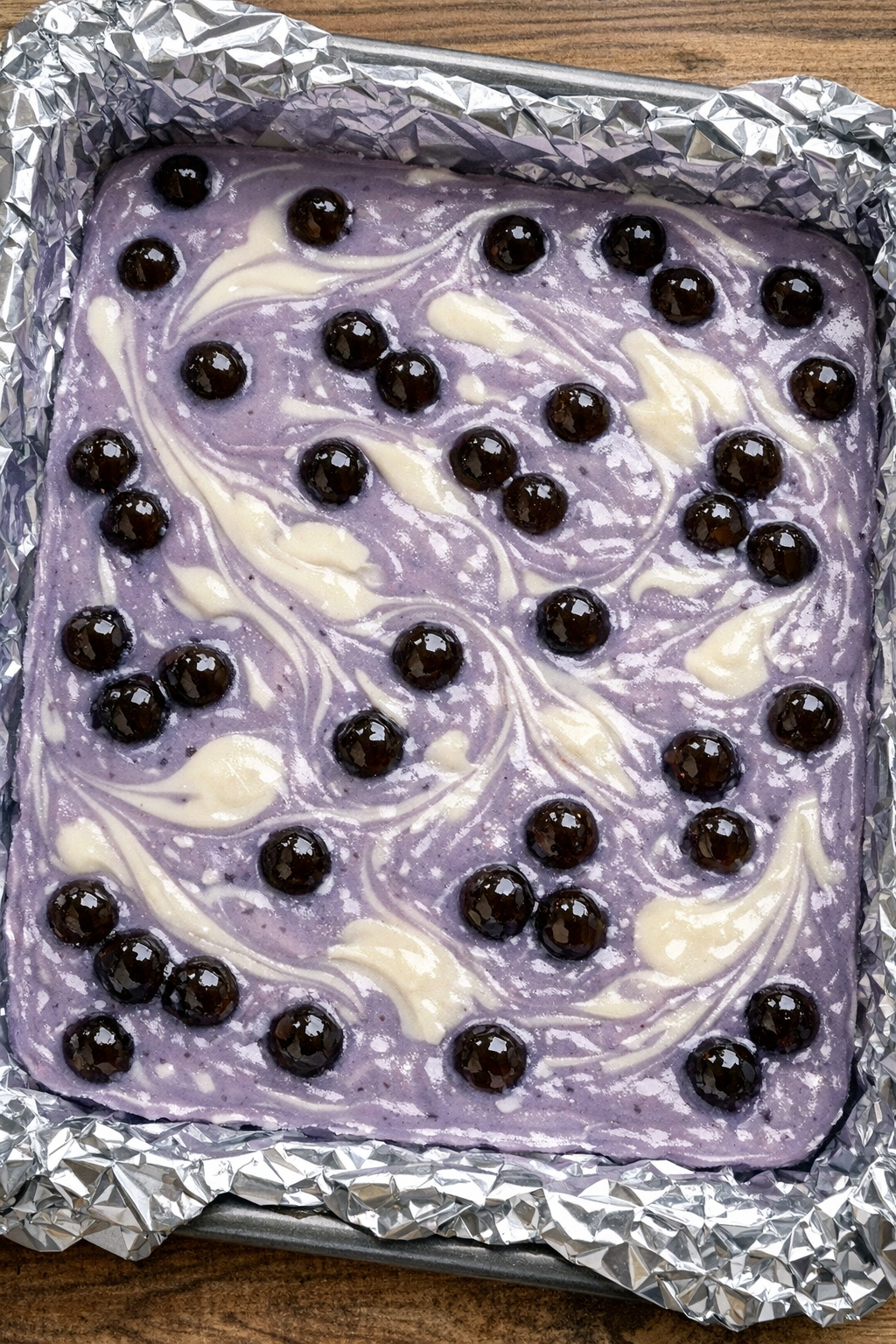 Slow cooker taro milk tea fudge in a foil-lined pan