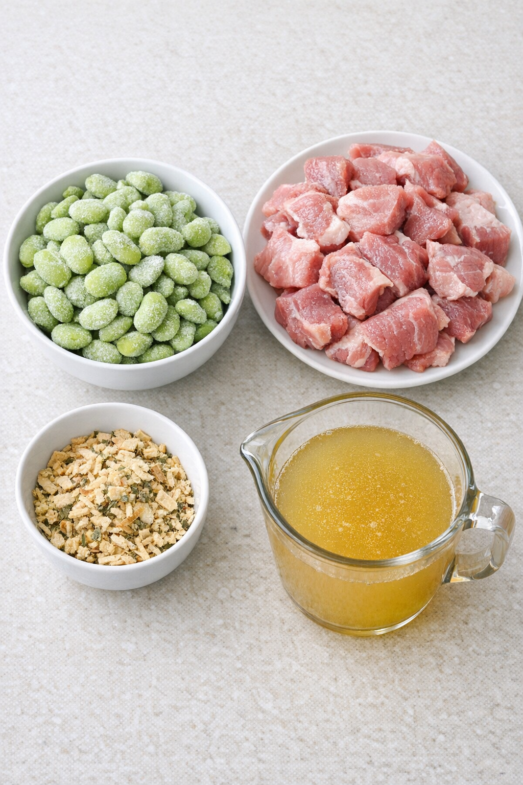 Main ingredients for lima bean pork arranged on a counter