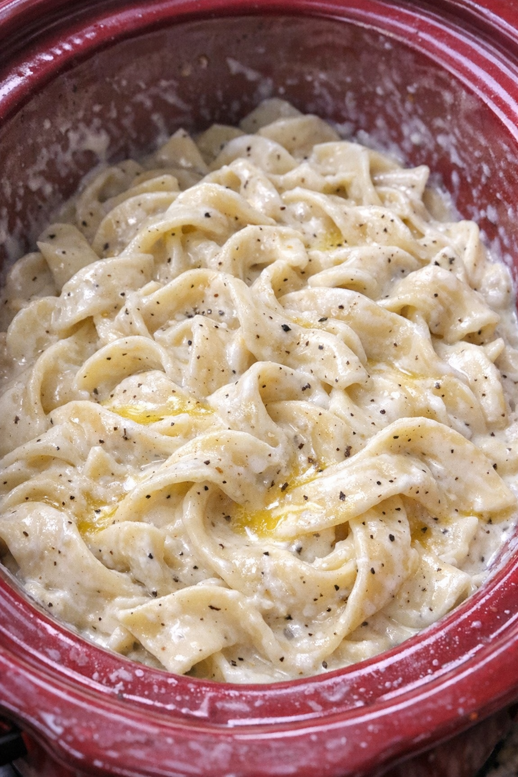 Creamy Amish sour cream noodles in a red slow cooker