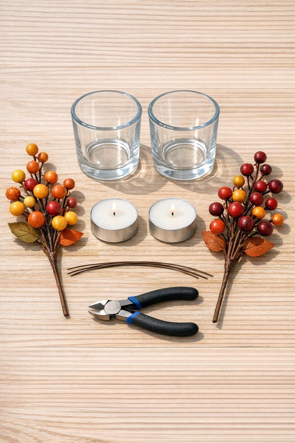 Materials for faux berry candle rings laid out on a table