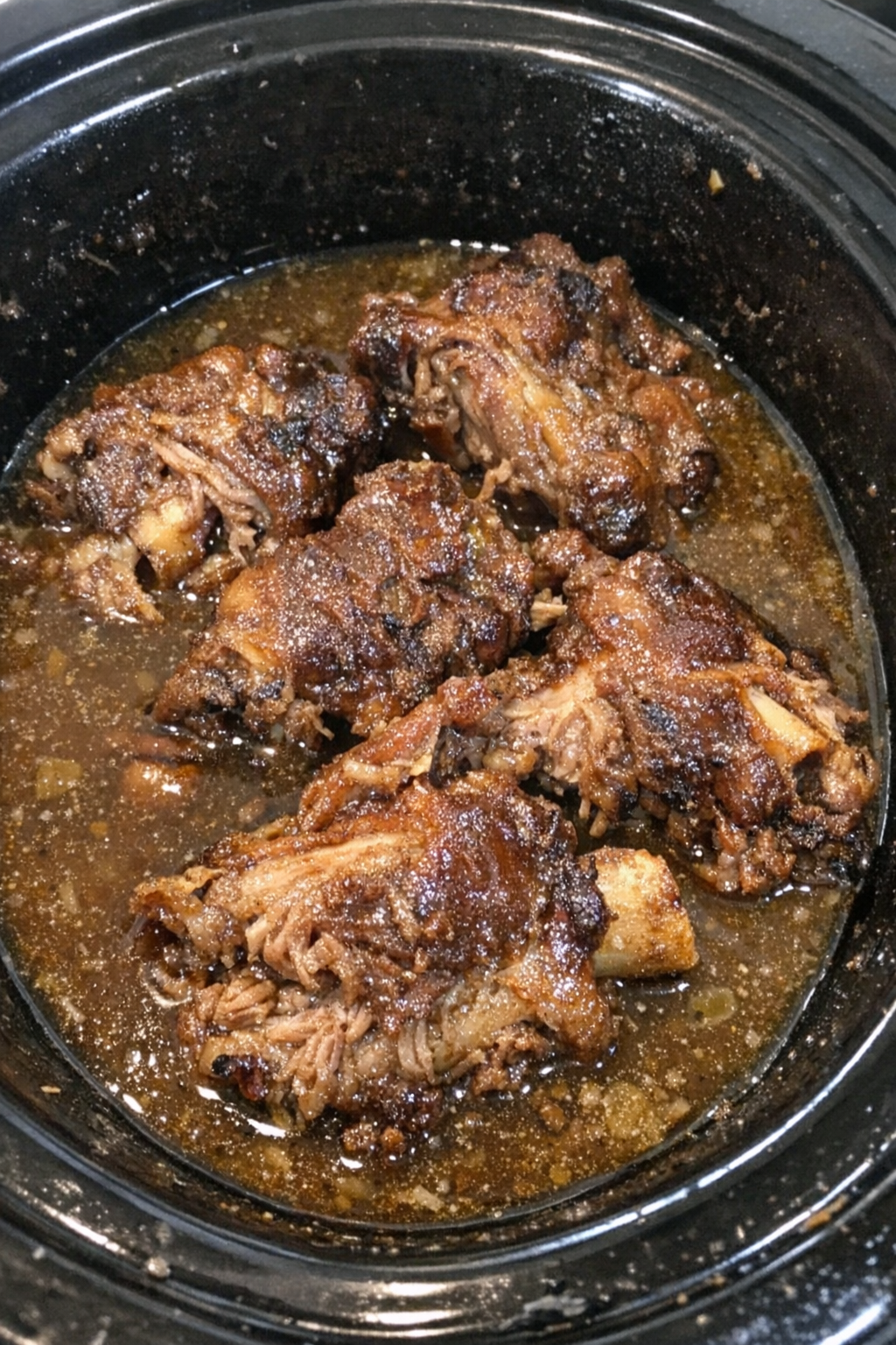 Slow cooker pork neck bones in glossy broth