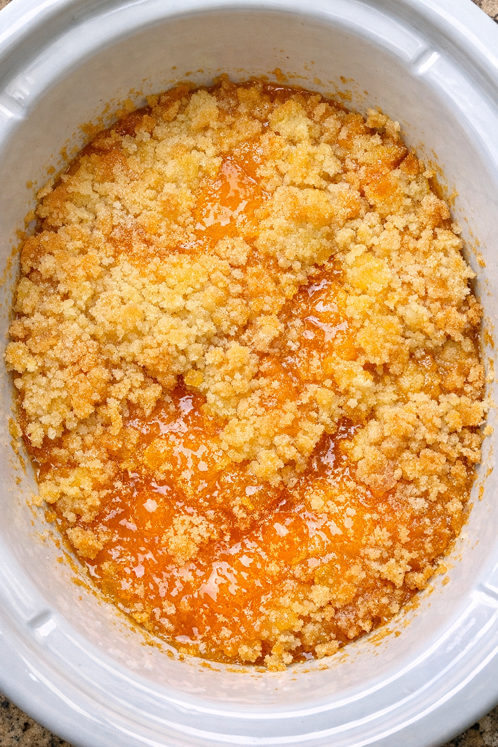 Slow cooker orange dump cake in a white slow cooker
