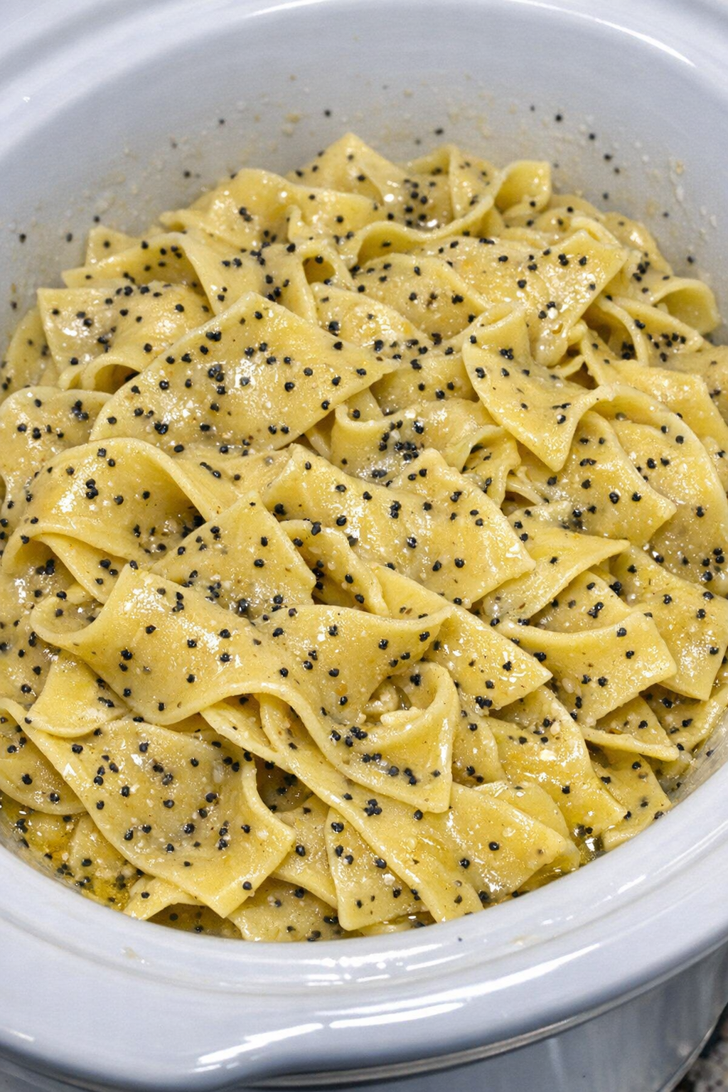 Slow cooker Amish poppy seed noodles in a white slow cooker