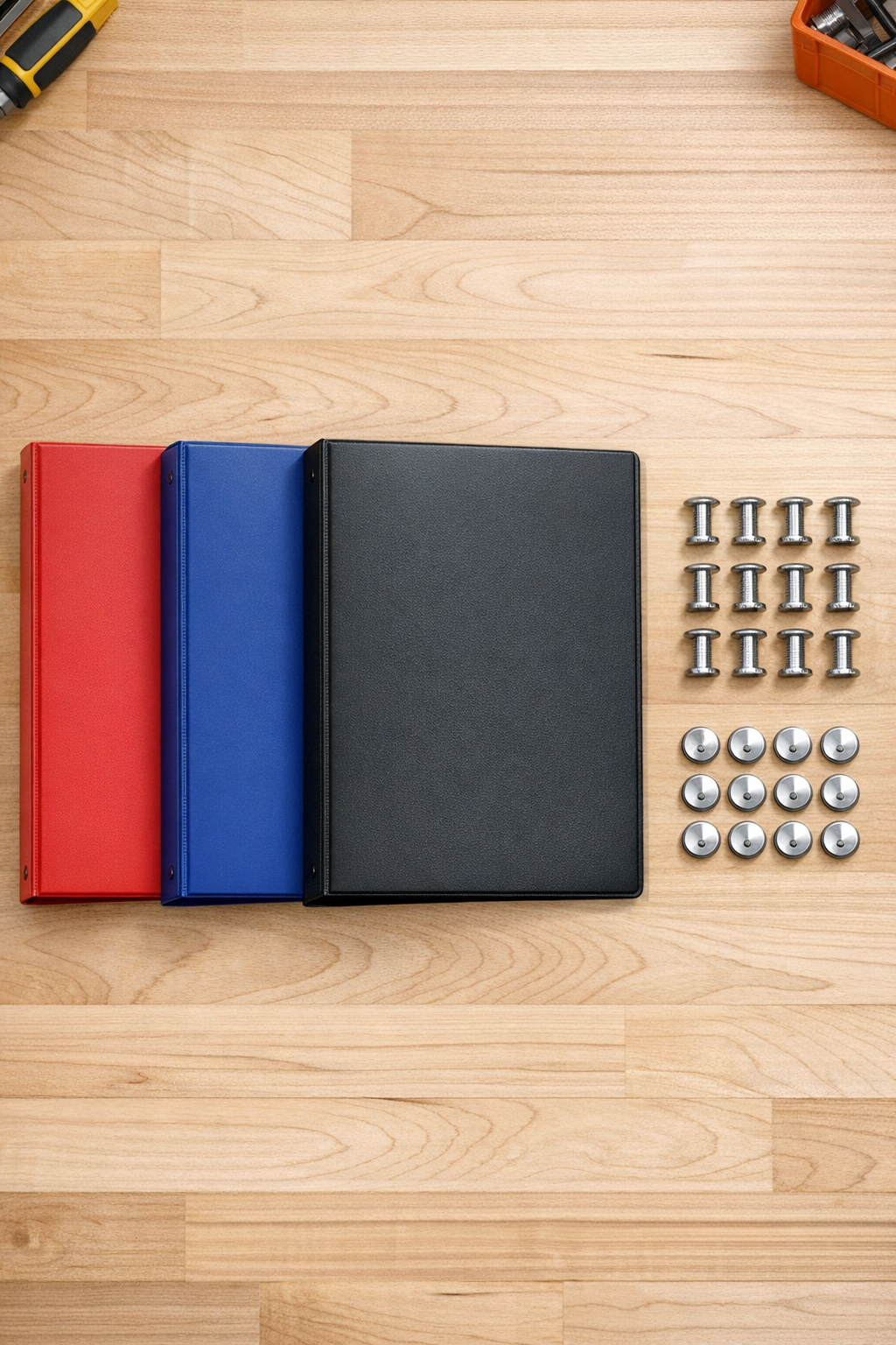 Plastic binders and Chicago screws laid out for the project