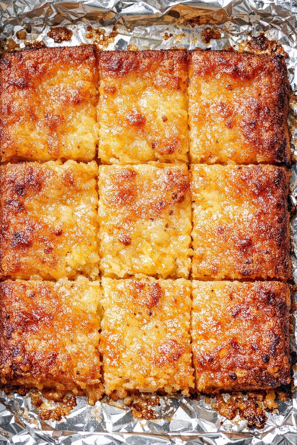Southern 3-ingredient cafeteria cheese squares on a foil-lined baking tray