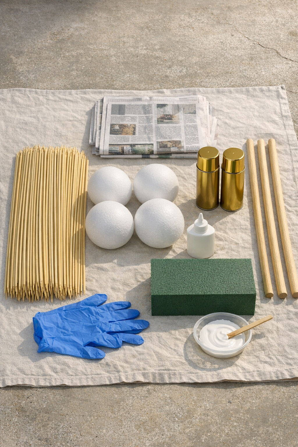 Materials for giant gold firework burst yard decorations laid out together