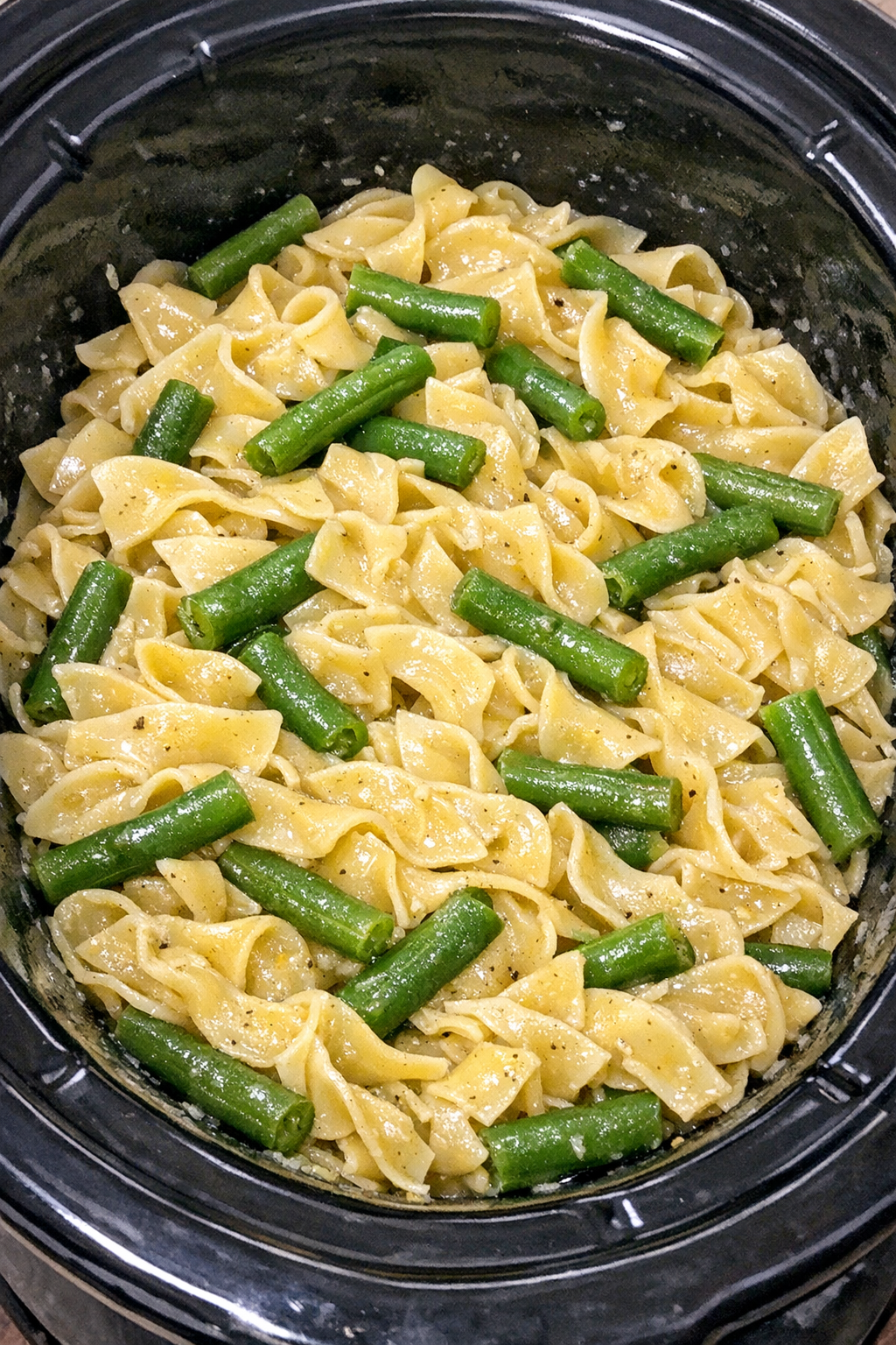 Slow cooker Amish green bean noodles in a black slow cooker