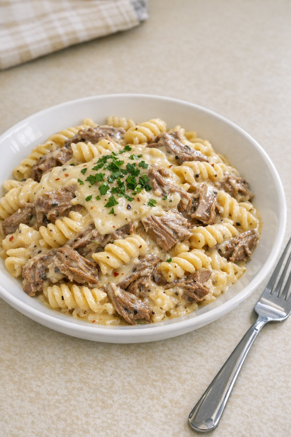 Finished pepper jack beef pasta plated in a shallow bowl