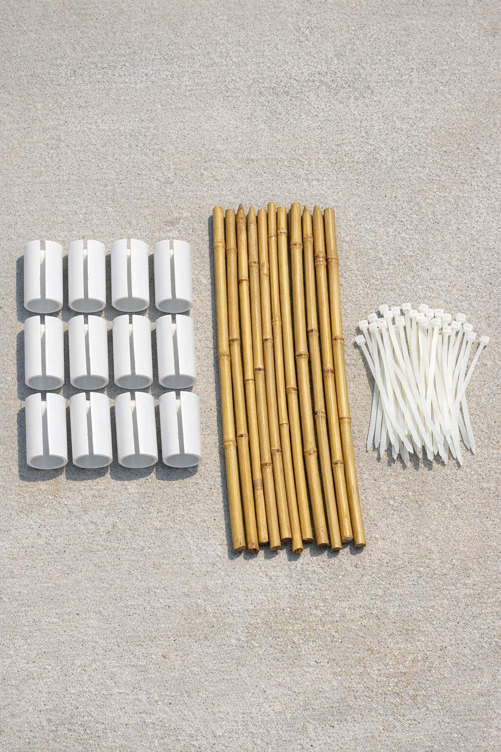 PVC pipe segments, bamboo stakes, and zip ties laid out neatly on a work surface