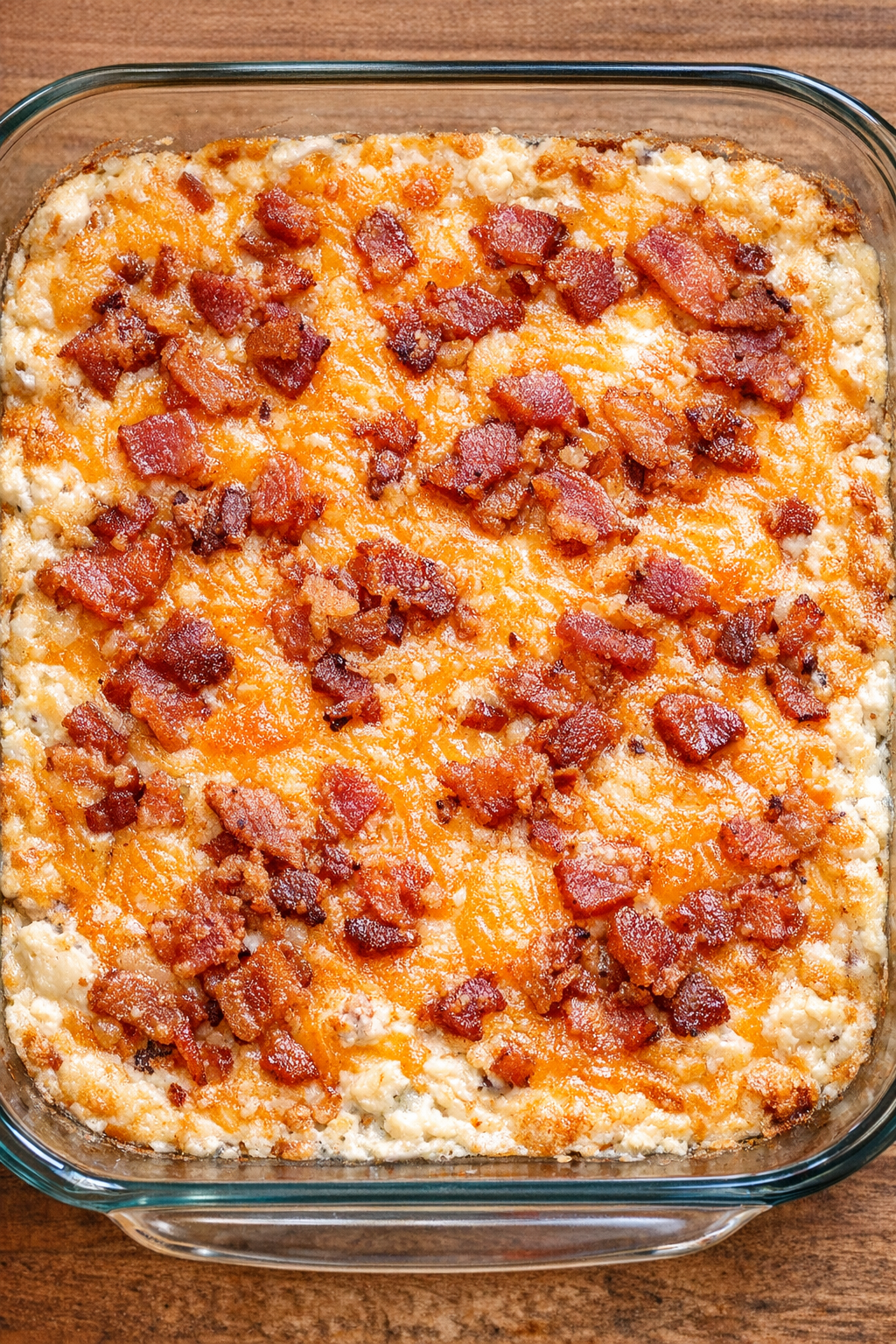 Baked cheddar bacon ranch dip in a glass casserole dish