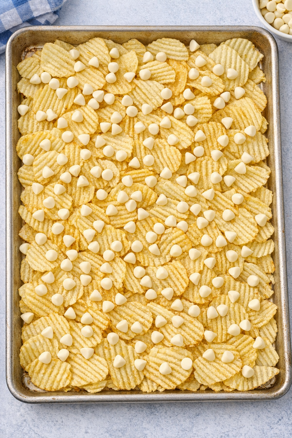 White chocolate sprinkled over potato chips