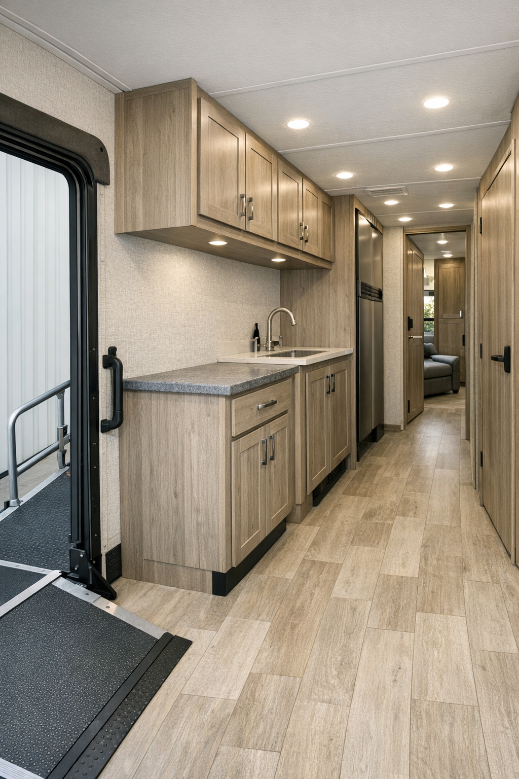 Accessible RV entry and hallway area with overhead storage and durable light flooring