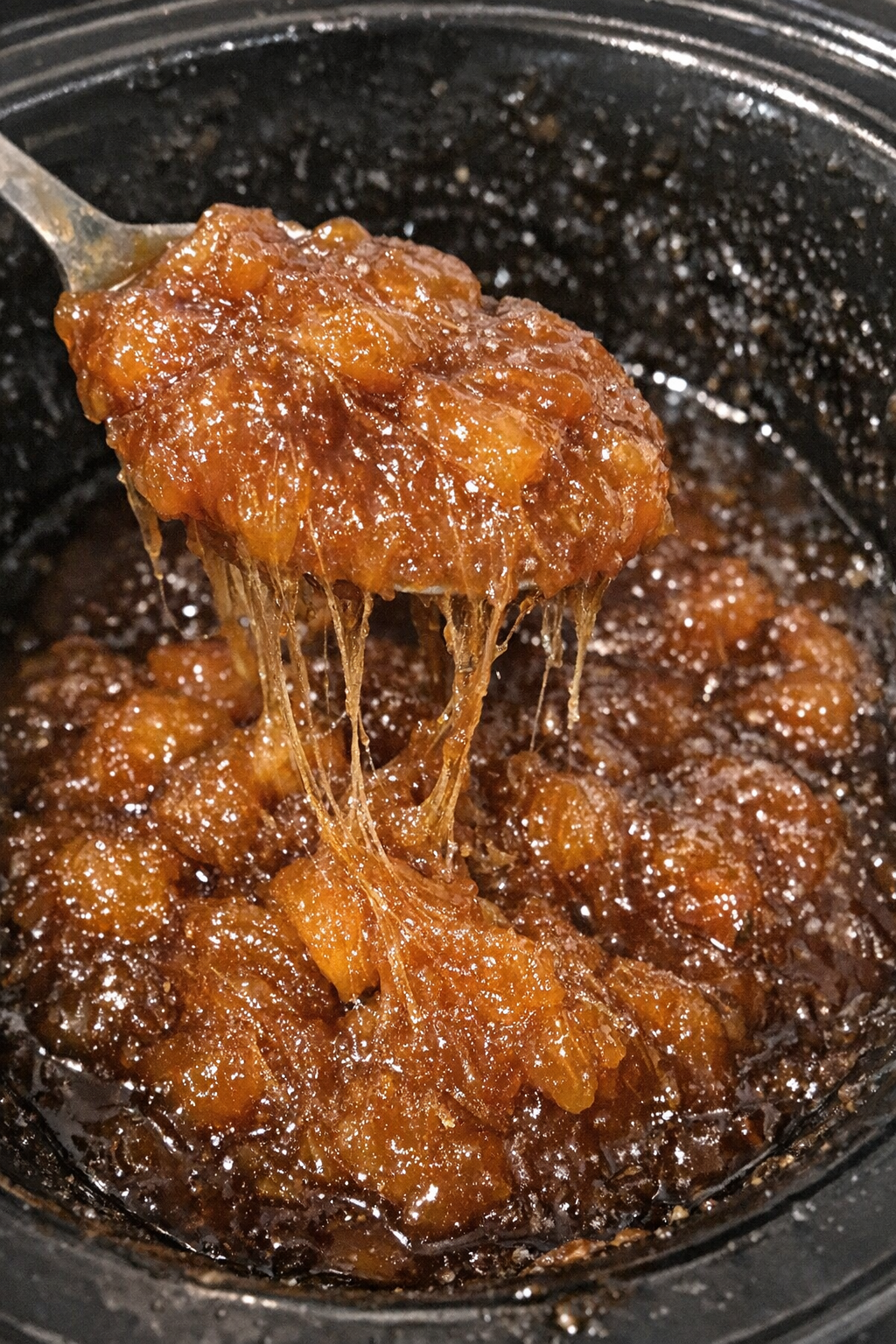 Dense glistening amber dessert in a slow cooker