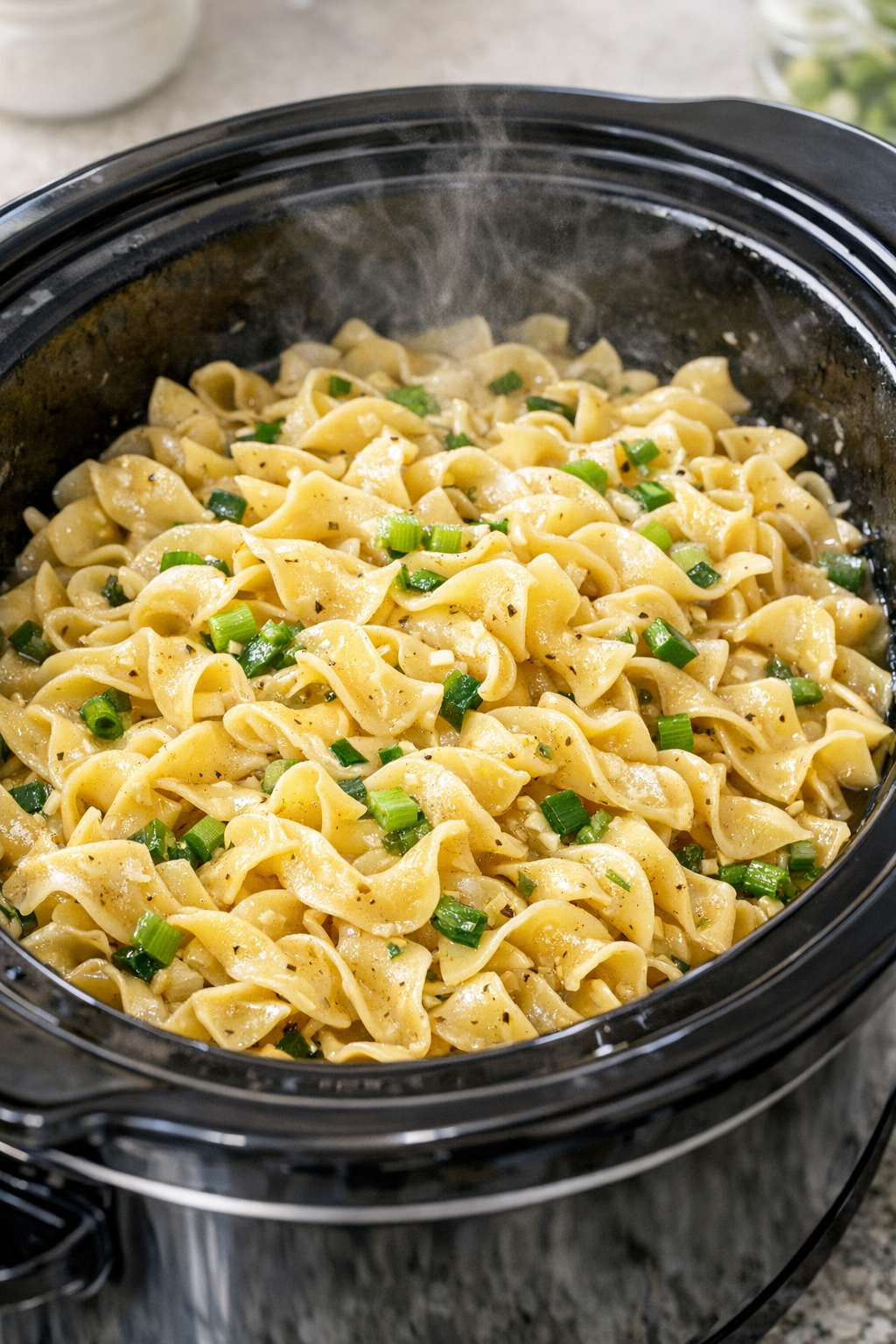Tender scallion noodles cooking in the slow cooker