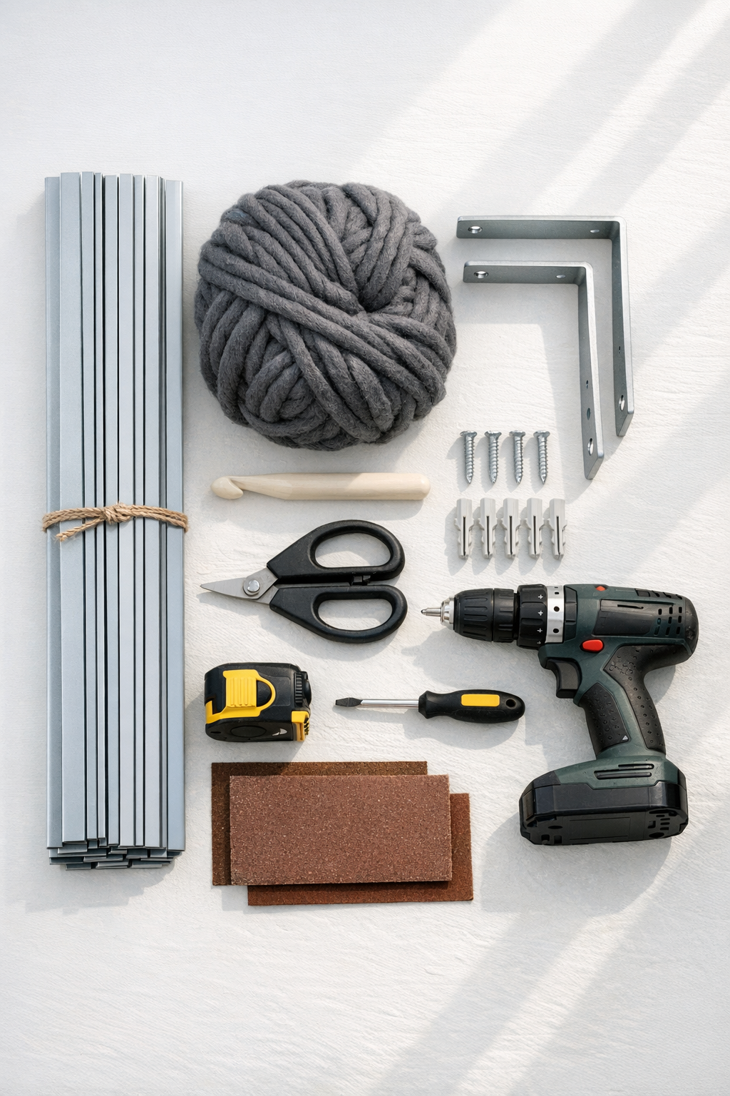 Materials for a crocheted blind slat wall shelf laid out on a worktable