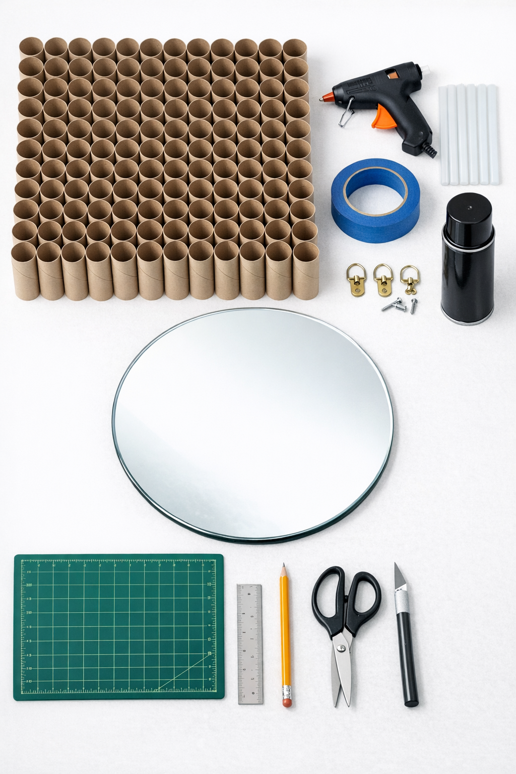 Materials for making a cardboard roll sunburst mirror laid out on a table