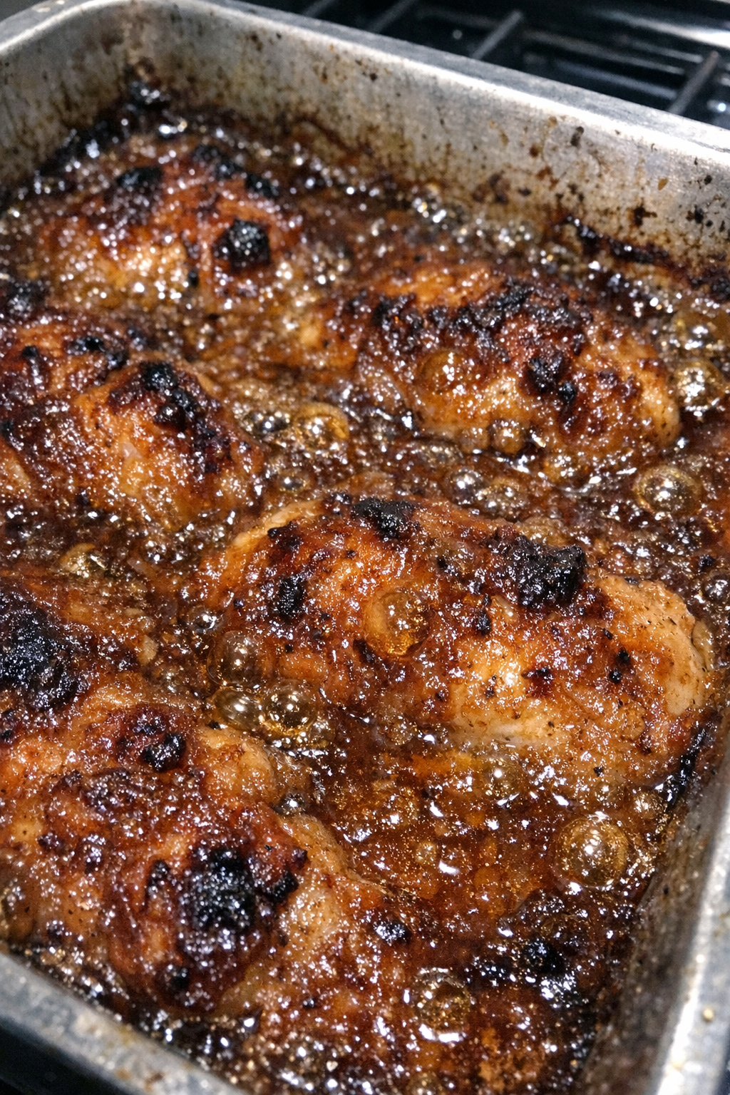 Bubbling caramelized baked dish in a metal pan