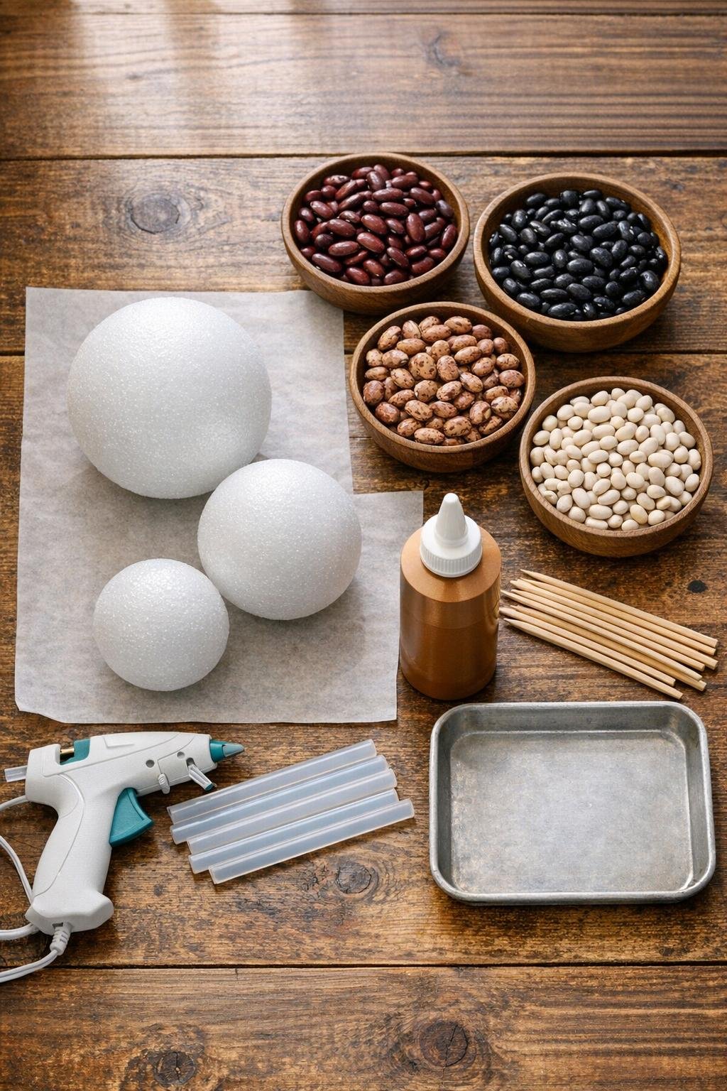 Materials for making bean-covered harvest spheres laid out on a table