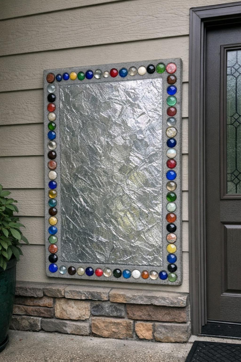 Decorative concrete door numbers panel near an entry