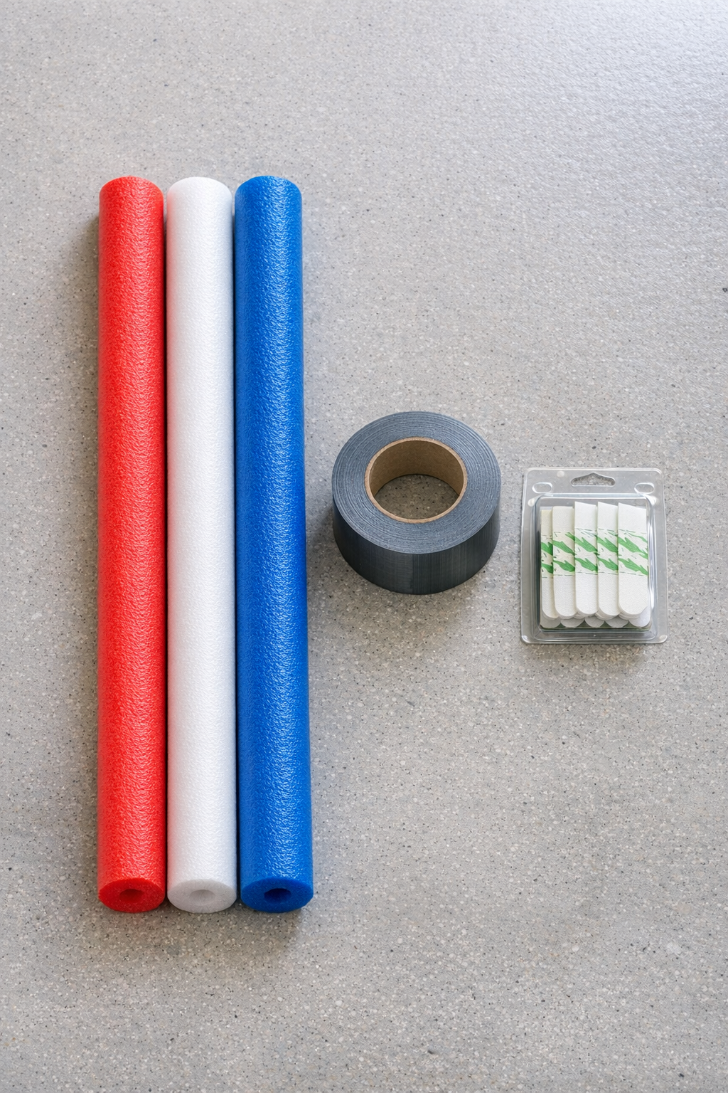 Pool noodles, duct tape, and mounting strips laid out for the project