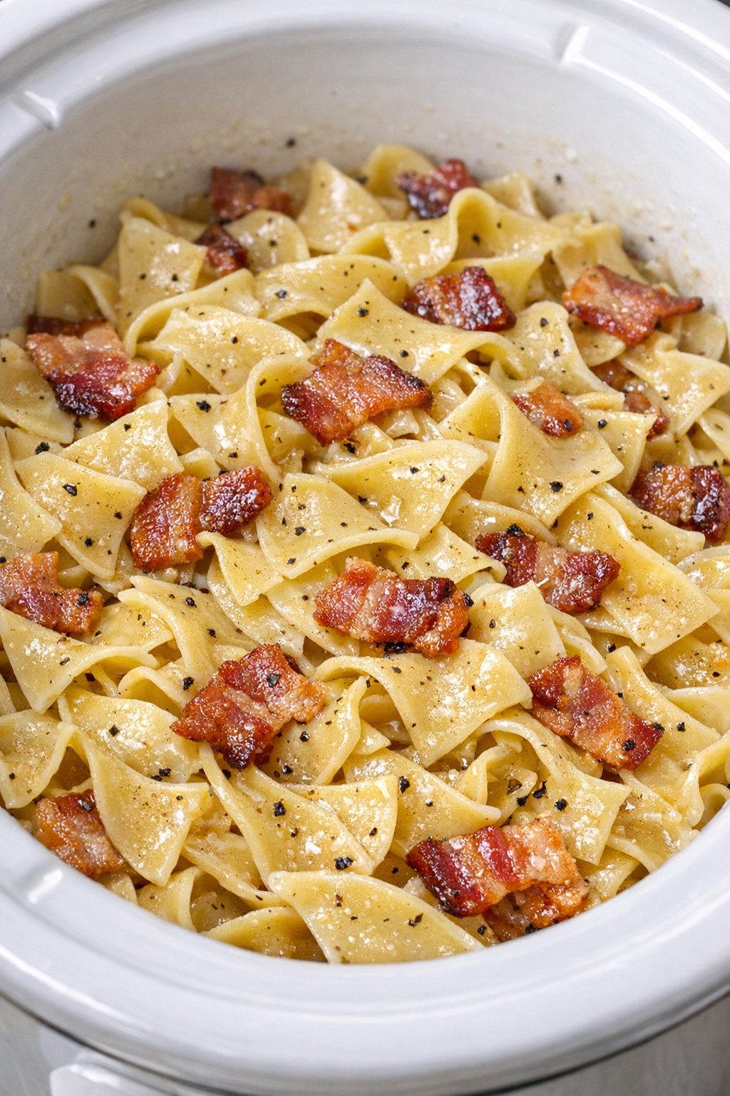 Slow cooker Amish bacon noodle pot in a white slow cooker