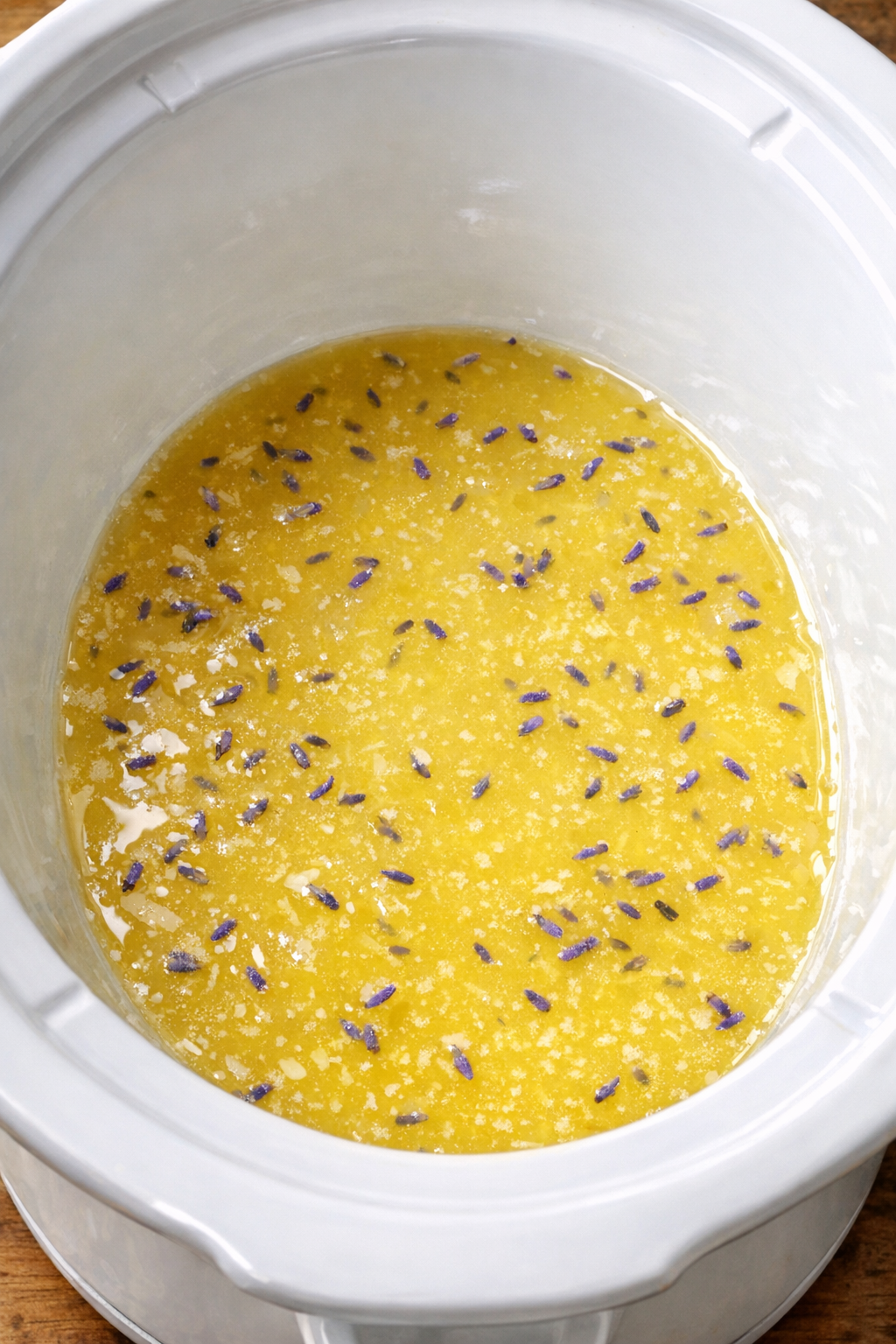 Lavender lemonade concentrate poured into a slow cooker