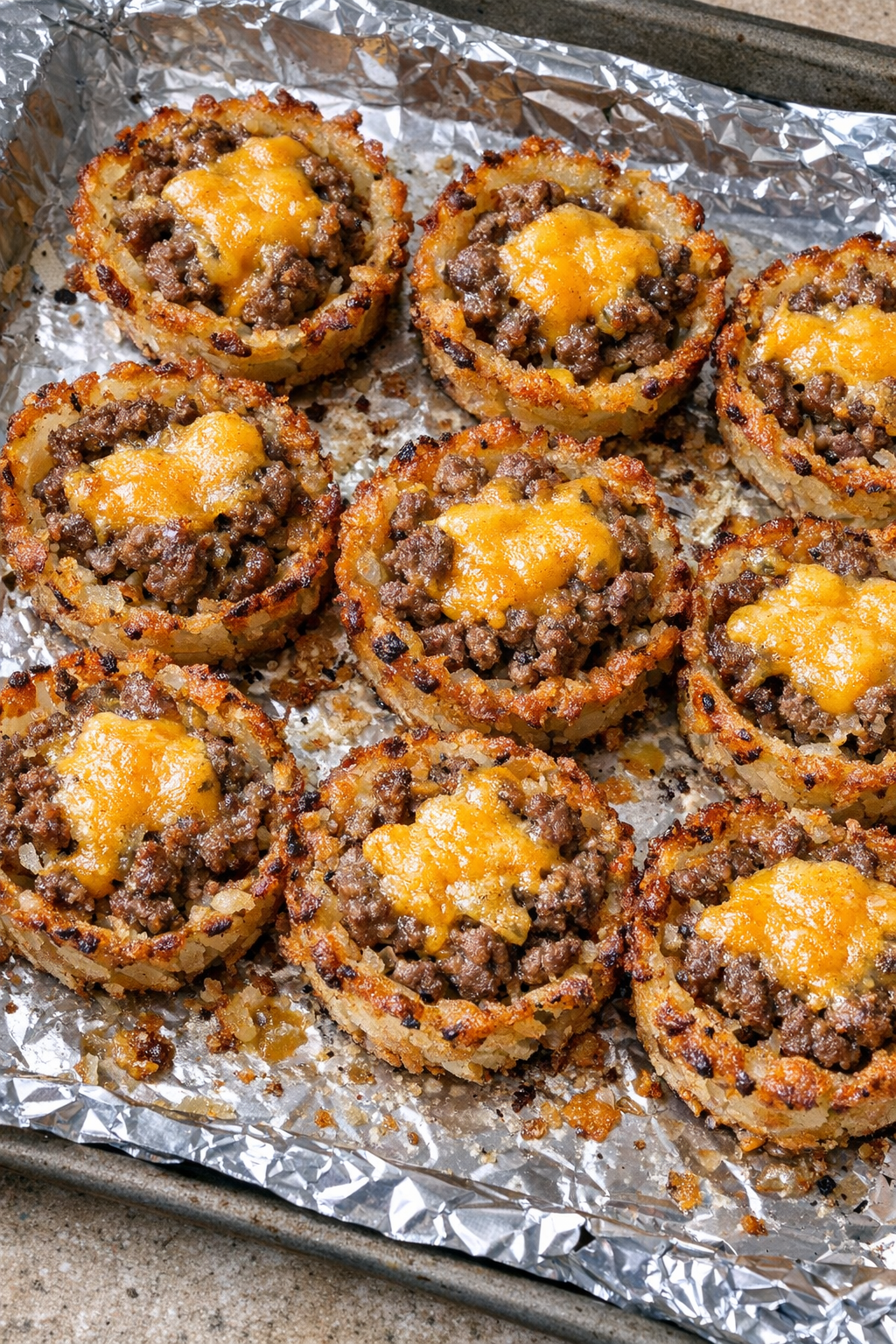 Crispy beef hash brown cups with cheddar cheese