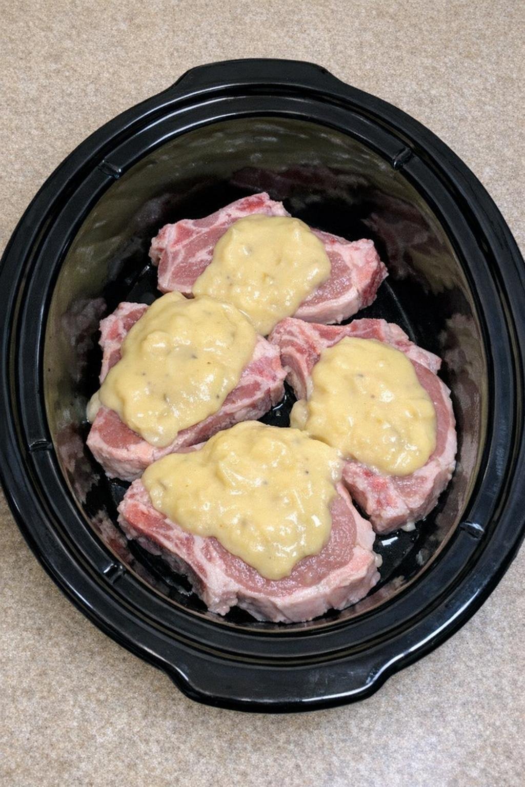 Condensed soup added over the pork chops