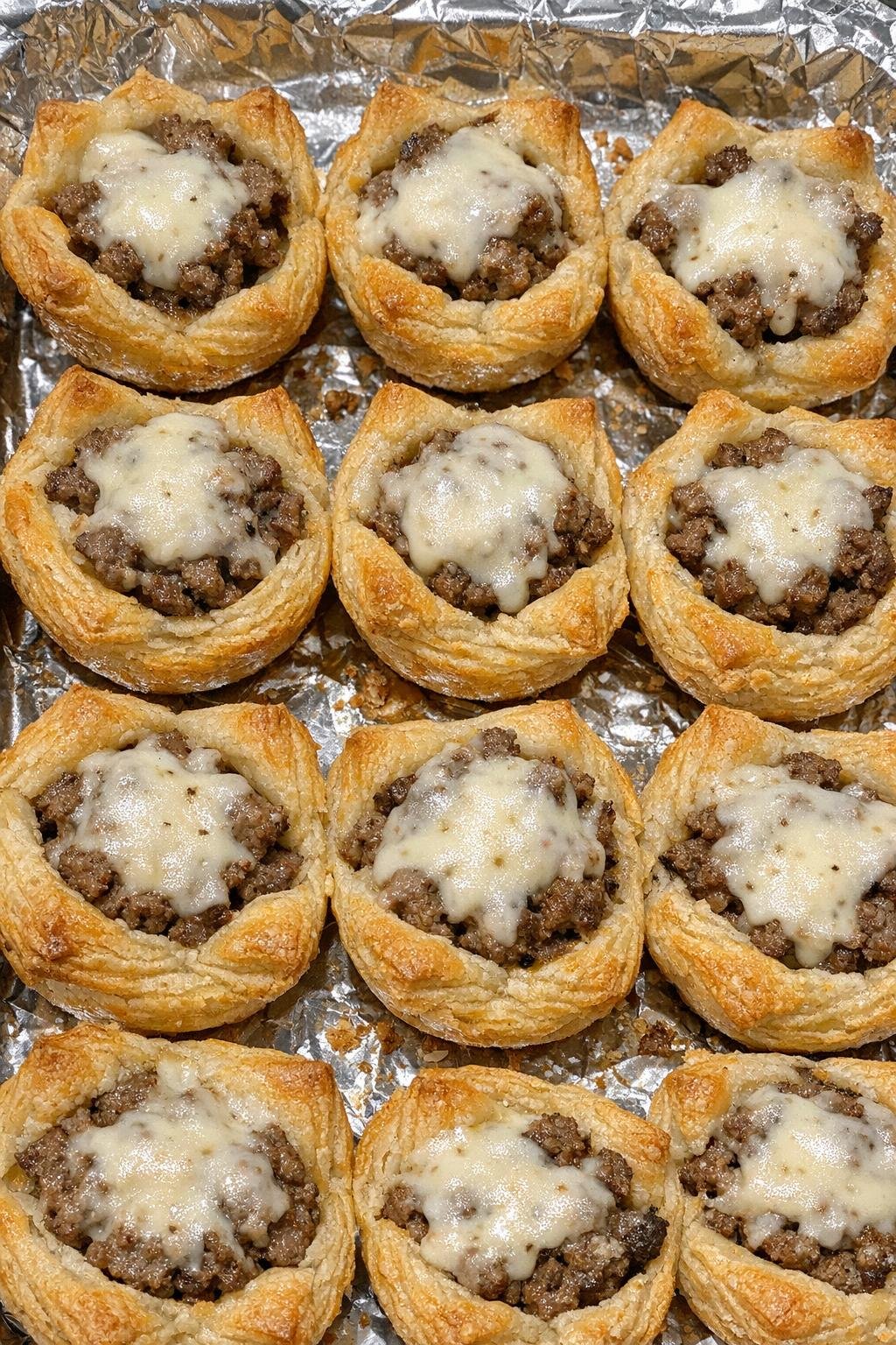 Golden beef pastry cups with melted provolone