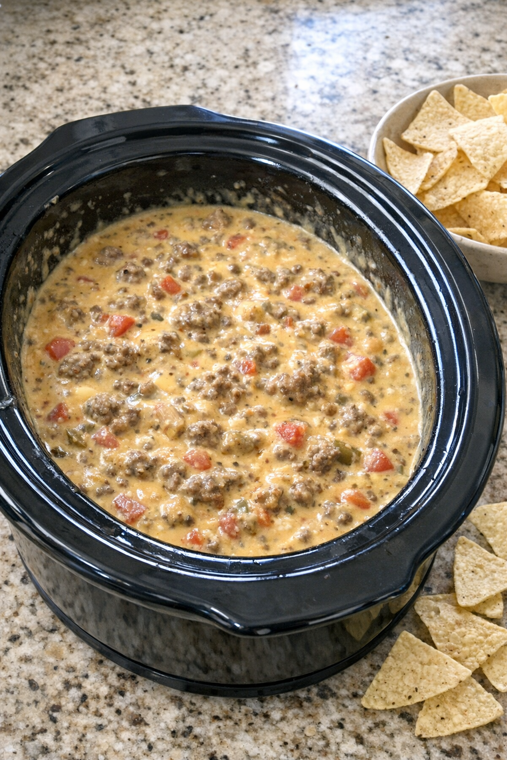 Finished beef queso dip in a slow cooker