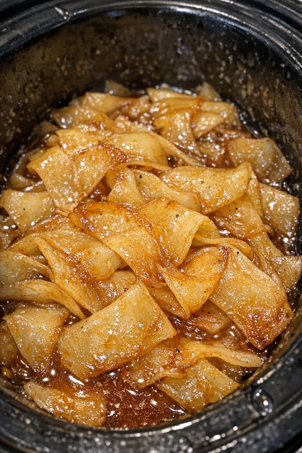 Glossy caramelized starchy ribbons in a slow cooker